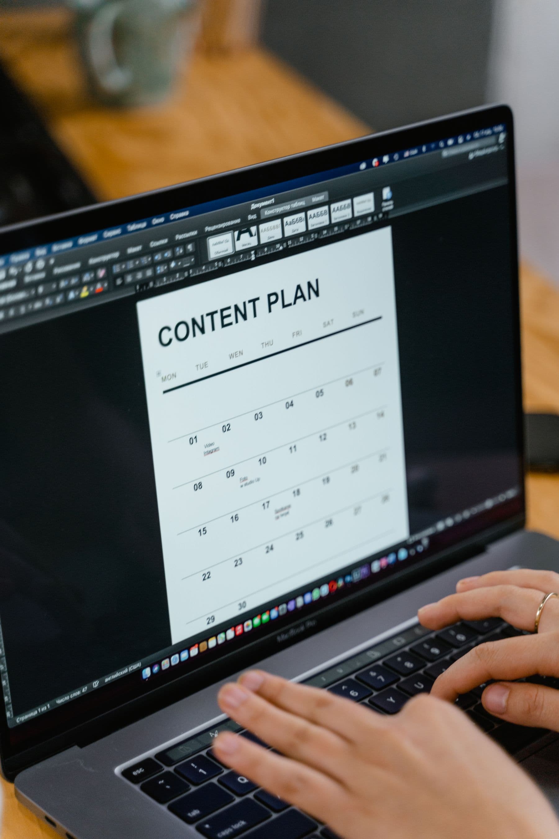 Person preparing a content plan with notes and documents at a desk.