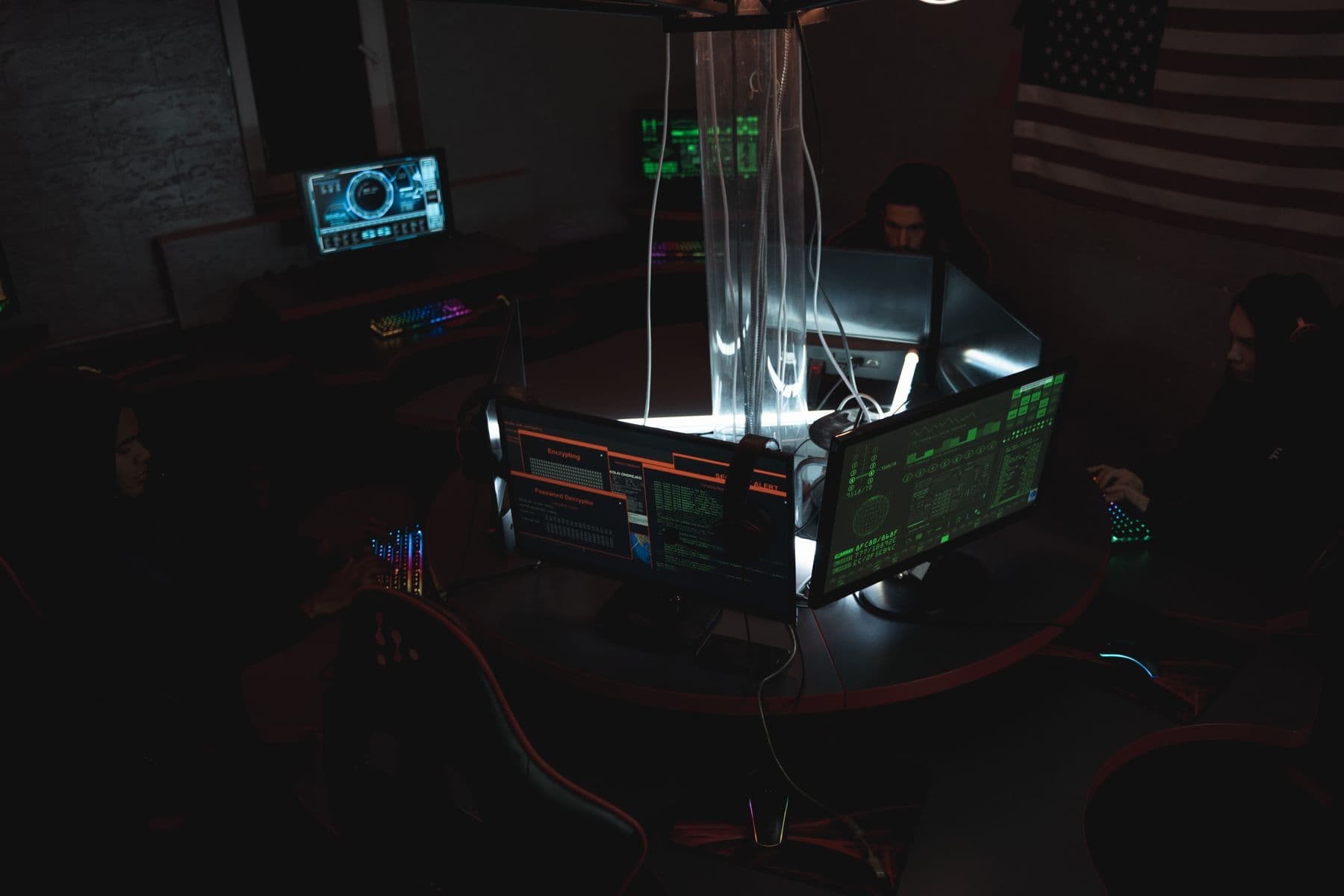 Professionals using computers together in a collaborative office environment.